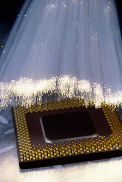 Close-up of a computer chip and optic fibers