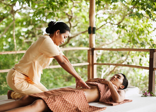 Woman Receiving Chi Nei Tsang, Taoist Abdominal Massage. Koh Samui, Thailand.