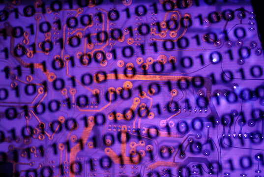 Binary code superimposed on a circuit board