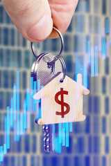 The keys to the new apartment in the hand of a man as a Real estate value growth concept