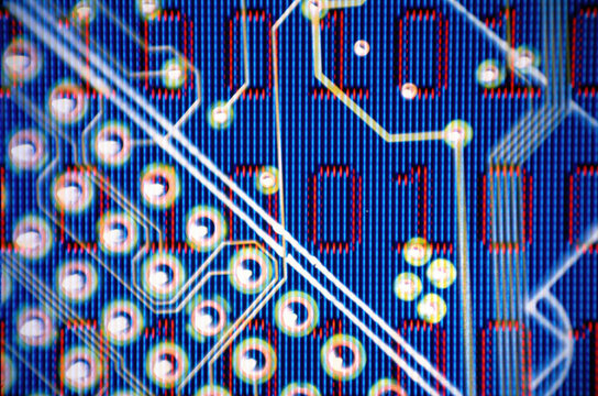 Binary code superimposed over a circuit board