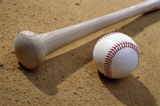 Close-up of a baseball bat and a baseball