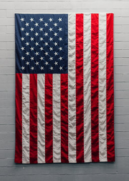 American Flag Draped On Concrete Wall