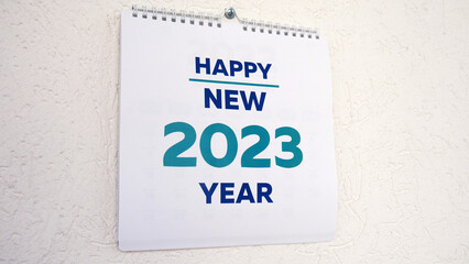 Close-up of the title page of a new 2023 calendar hanging on the wall