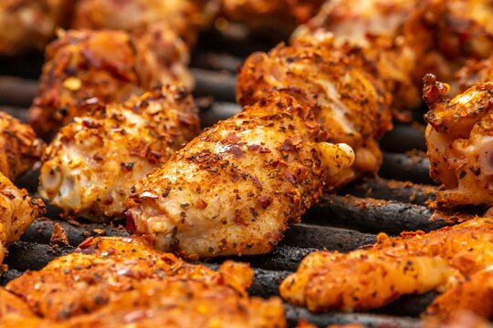 Closeup shot of marinated chicken meat on the grill