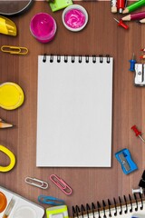 Back to school concept. Notepads pens erasers on  background