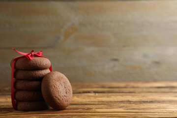 Tasty homemade chocolate cookies on wooden table. Space for text