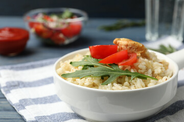 Delicious chicken risotto served in bowl on table