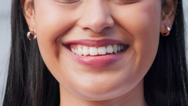 Face, closeup and mouth of woman with a smile or smiling with her lips. Beauty, confidence and empowerment of proud attractive casual happy girl smiling with perfect teeth and earrings portrait.