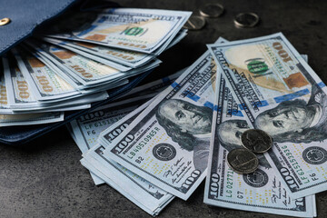 Fototapeta premium Dollar banknotes, coins and wallet on grey table, closeup. Money exchange