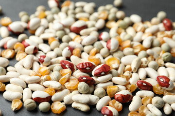 Mixed vegetable seeds on grey background, closeup