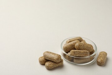 Dietary supplement pills on white background. Space for text