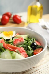 Delicious crab stick salad served on wooden table, closeup