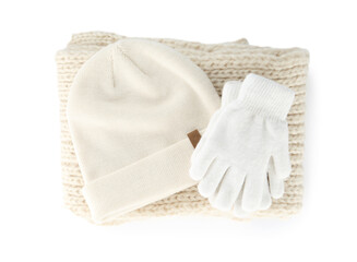 Woolen gloves, scarf and hat on white background, top view