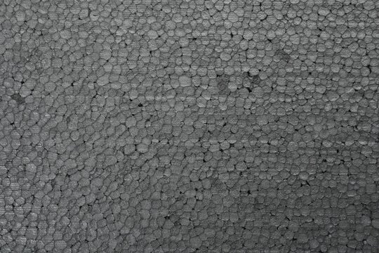 Texture of grey styrofoam sheet as background, closeup