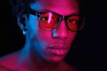 Fototapeta na wymiar African American man portrait in sunglasses, isolated on purple background