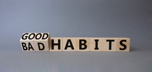 Good and bad Habits symbol. Turned wooden cubes with words Bad Habits and Good Habits. Beautiful grey background. Medicine concept. Copy space