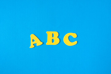 Back to school supplies and letters on a blue background. Beginning of the school year
