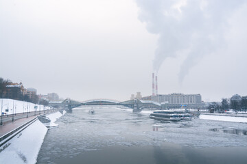 power station and ship in the river in city in winter