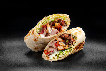 Beef shawarma on a dark background. Shawarma with beef in pita bread