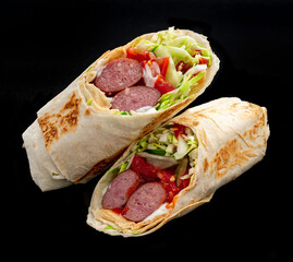 Shawarma with grilled sausage, vegetables and tomato sauce. Sausage in pita.