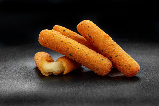 Cheese sticks on the black background