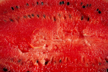Red pulp of ripe watermelon texture. Background red pulp of ripe watermelon with pits.