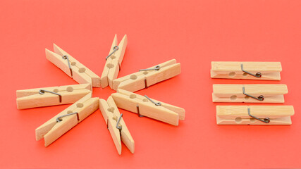 wooden clothespins and paper close-up on a red background