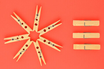 wooden clothespins and paper close-up on a red background