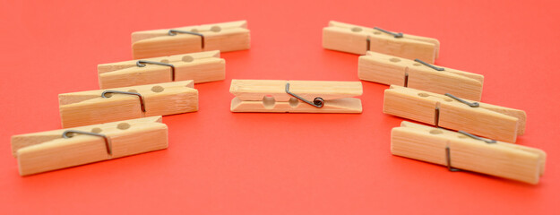 wooden clothespins and paper close-up on a red background