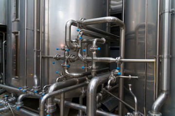 A stainless steel pipe system in the food industry at a brewery in the process of brewing beer....