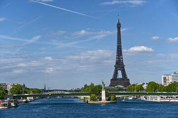 Fototapeta na wymiar Paris,France.June 2022.Amazing shot that collects two symbols of France: the Eifell tower and the statue of liberty at the base.An iconic image of the city on a beautiful summer day