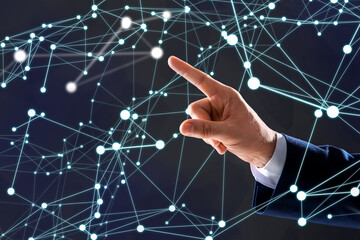 Man using virtual screen with connection lines presenting innovation network linkage on dark background