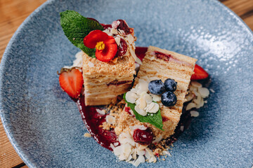 There are two slices of delicious cake in the blue bowl in the restaurant.