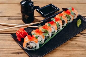 There are a interesting sushi on the decorative black plate in the Japanese restaurant.