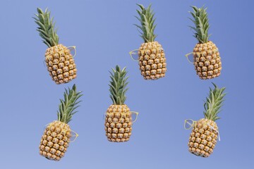 abstract background consisting of patterns of pineapples scattered over a blue background. 3d render