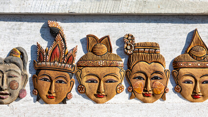 Asian souvenirs. Wooden faces of Asian people.