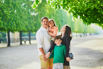 Happy family of four enjoying their trip to Paris, France