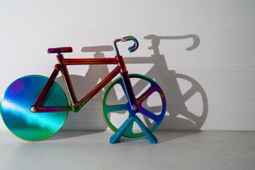 colorful bicycle and visible shadow, creative effect of sunlight, reflection on the wall, mirroring volume, healthy lifestyle, cardio exercise, fitness, children toy, sport