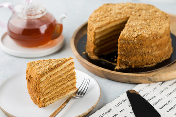 Homemade honey cake with sour cream on a table