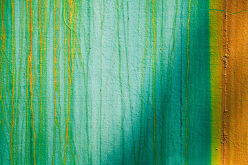 colored background - a rusty sheet of painted iron - old blue paint and rust formed a beautiful pattern, turquoise and orange vertical stripes with light and shadows