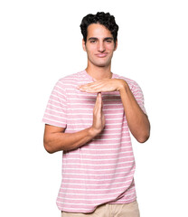 Stressed young man making a time out gesture with his hands