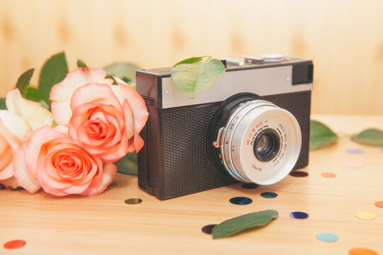 Old film camera with roses flowers, beautiful abstract vintage card
