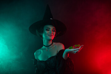 Photo of lady in fiction personage dress halloween theme event hold marmalade jelly isolated on mystic dark background