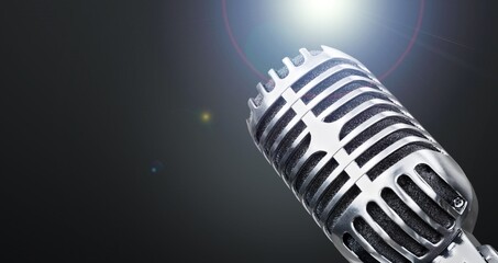 Fototapeta na wymiar Classic black microphone with stage lighting background