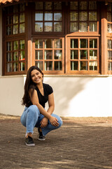 Fototapeta premium Smiling young girl posing in a park