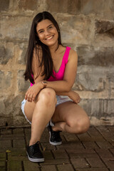 Smiling young girl posing in a park