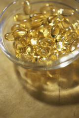 Close-up of a glass full of vitamin capsules