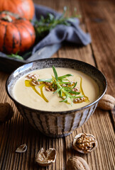 Creamy pumpkin and walnut soup in a bowl