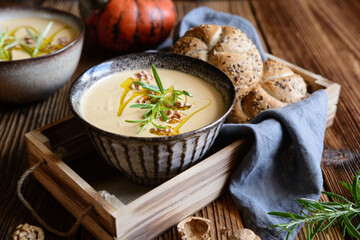 Creamy pumpkin and walnut soup in a bowl